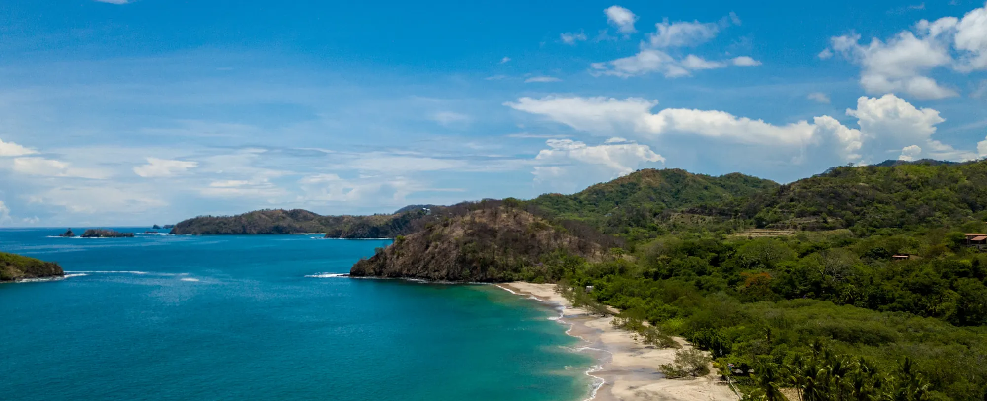 A bay on the Guanacaste coast of Costa Rica with the beach, headland and forest behind it